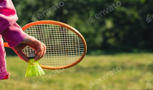 Preview: Unrecognizable woman playing with Wooden badminton rackets and shuttlecocks soft focus concept. Copy