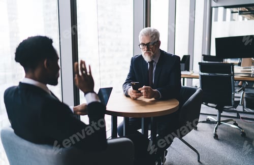 Preview: Multiracial colleagues using gadgets in workplace