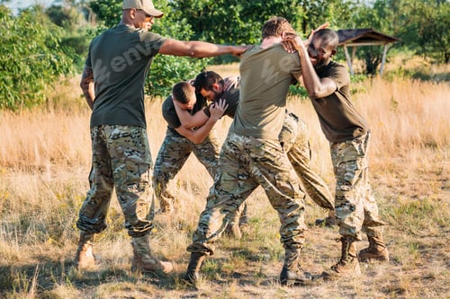 Preview: multiracial soldiers in military uniform practicing hand to hand fighting on range