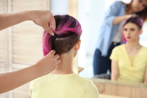 Preview: Professional hairdresser working with young woman in beauty salon. Trendy hair color