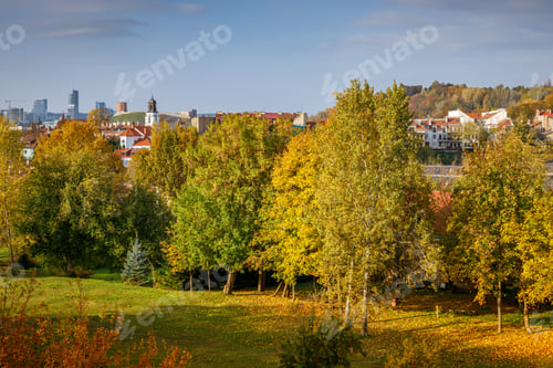 Preview: A sweeping autumn view of Vilnius, Lithuania, showcasing golden and orange foliage in the foreground