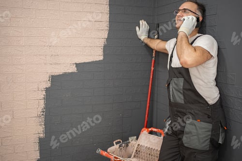 Preview: Man in Overalls Talking on a Cell Phone
