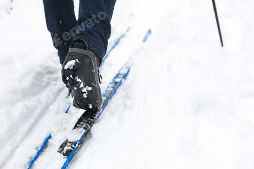 Preview: Feet of a skier in ski boots on cross-country skis.
