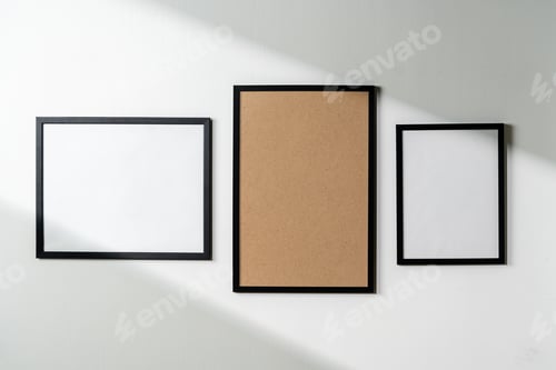 Preview: Blank picture frames on the white wall copy space