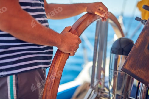 Preview: Sailor Using Wheel To Steer Rudder On A Sailing Boat.