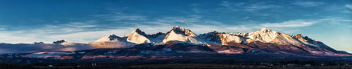 Preview: Panoramic shot of winter mountain landscape during sunset. High