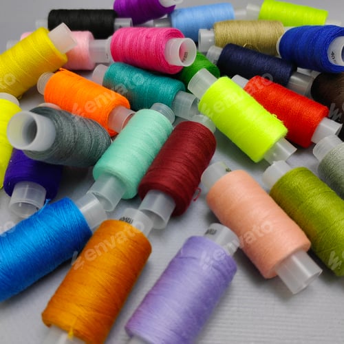 Preview: background of coils on which colored sewing threads are wound