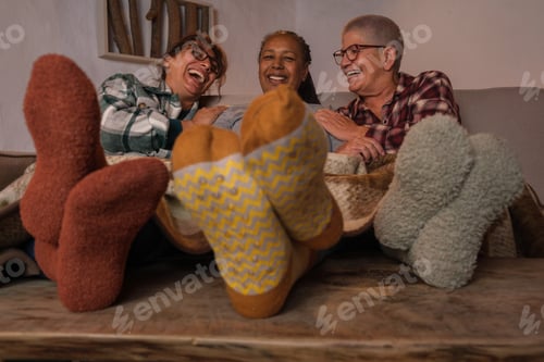 Preview: Three middle-aged female friends by the fireplace in winter and having a pleasant evening.