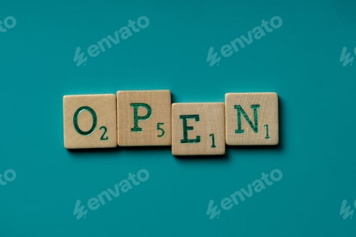 Preview: Wooden letters spelling the word open on a blue background.
