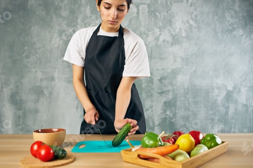 Preview: Woman Cutting Cucumber for Healthy Vegetable Meal