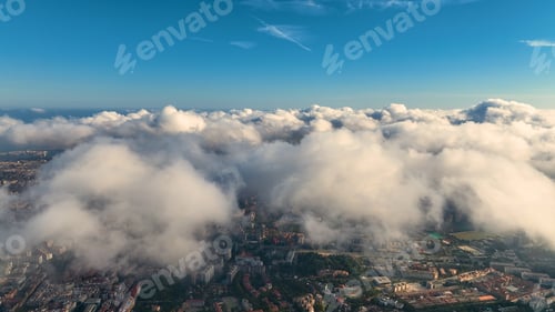 Preview: Aerial view of Barcelona City skyline above the clouds and fog, Catalonia, Spain