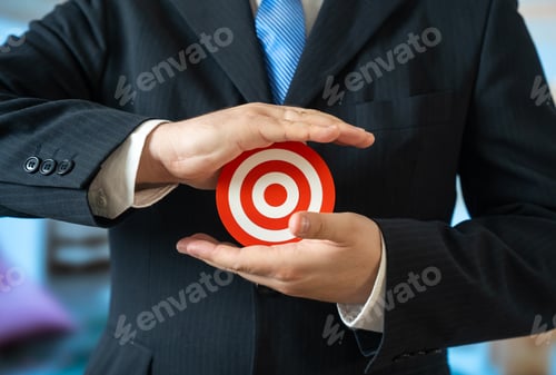 Preview: A man in a business suit holds a target in his palms. A candidate for a position.