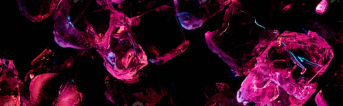 Preview: panoramic shot of transparent ice cubes with purple lighting isolated on black