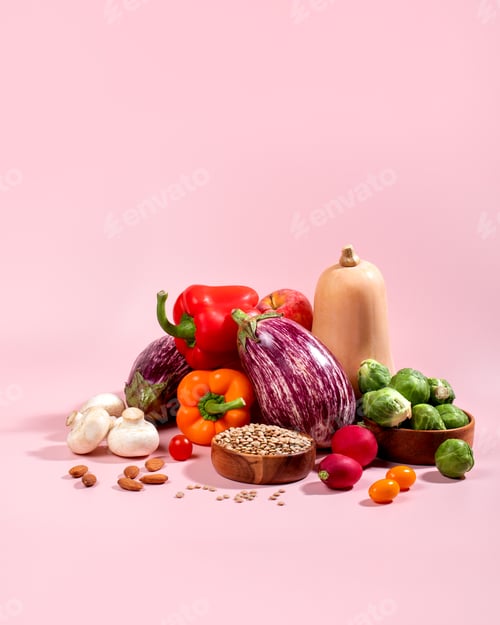 Preview: Vegan background with fresh seasonal autumn vegetables, vegan fall still life on pink
