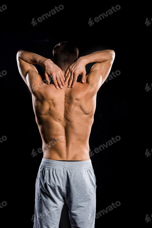 Preview: back view of muscular shirtless sportsman standing isolated on black