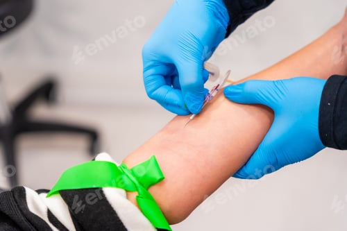 Preview: Nurse using needle to extract blood sample from a woman