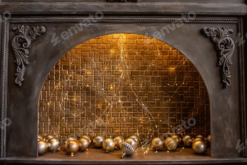 Preview: Fake of an old wooden fireplace with an ornament, decorated with brick wall, garland, golden balls