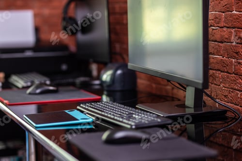 Preview: Two computer monitors with black screen on a desk, one workplace on table for two people