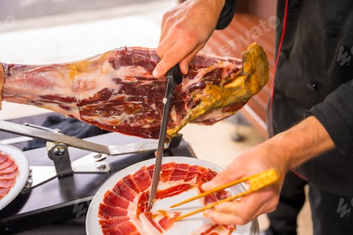 Preview: Ham cutter man. Service of a person cutting a piece of ham. Chef or cutter with