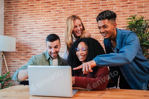 Preview: Group of young adult friends having fun using a laptop sharing on the social media. Happy and smling