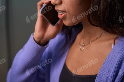 Preview: Cropped view of young woman having phone conversation