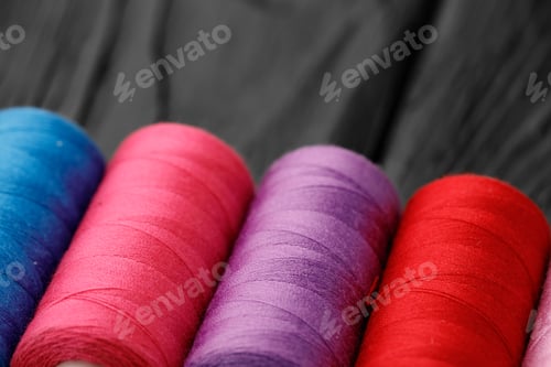 Preview: Close up of colored thread coils, thread spools background