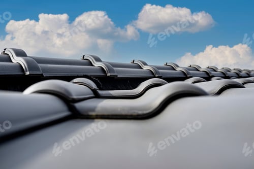 Preview: Ridge tile on the roof of a single-family house covered with a new ceramic tile