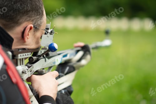 Preview: A determined male athlete practices for an upcoming competition with a free rifle