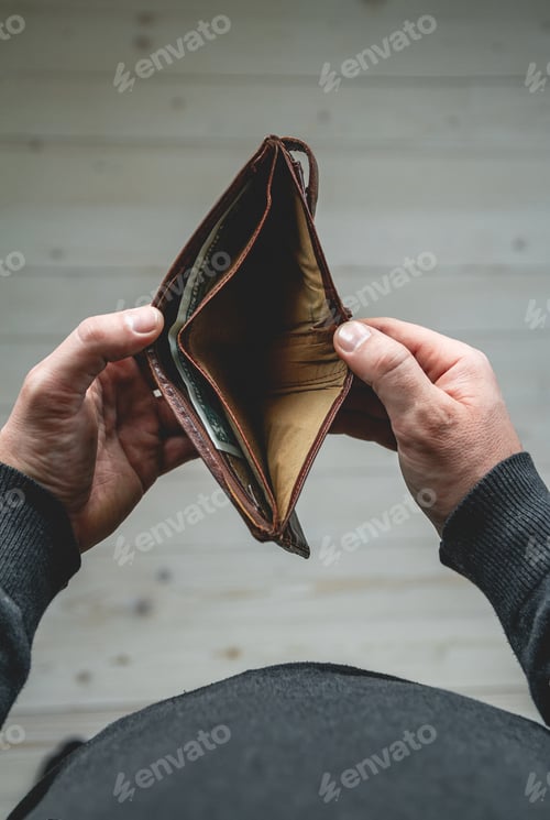 Preview: Empty wallet in the hands of a young man