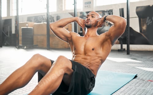 Preview: Its not about the amount of reps you do. Shot of a young man completing crunches.