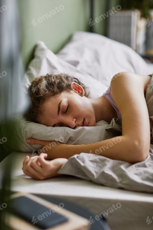 Preview: Tired woman sleeping in her bed