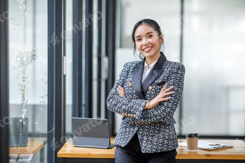 Preview: Charming Young Asian businesswoman standing in the office. Looking at camera.