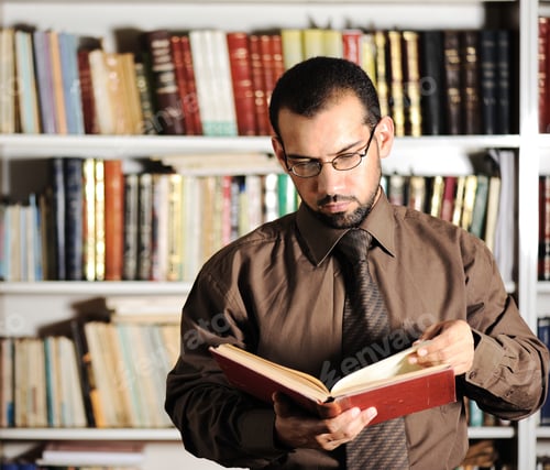 Preview: Young Man Reading Book In Library