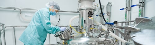 Preview: Pharmaceutical factory woman worker in protective clothing operating production line in sterile