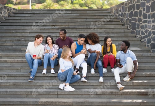 Preview: Young multiracial group of friends using mobile smartphone sitting on stairs out of college
