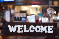 Preview: Wooden welcome sign in a restaurant or diner