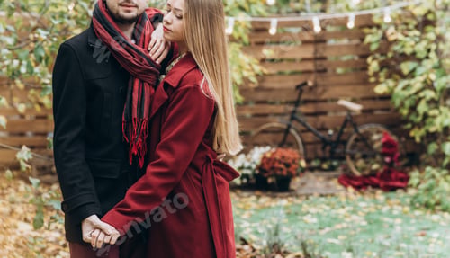 Preview: Happy couple. Young cute female hugs her boyfriend in autumn outdoor