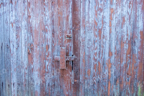 Preview: old wooden door painted blue, with worn paintwork
