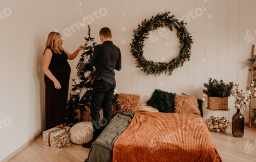 Preview: Loving Couple Decorating Christmas Tree at Home