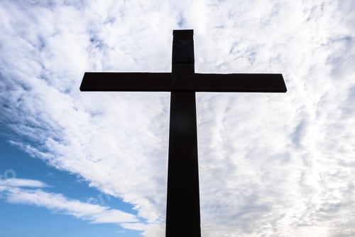 Preview: Old rusty metal cross against a blue sky with white clouds. Ideal for concepts and events.
