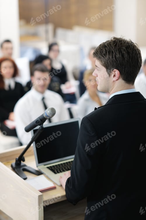 Preview: Young Male Business Man Giving A Presentation At A Meeting Seminar At Modern Conference Room On A