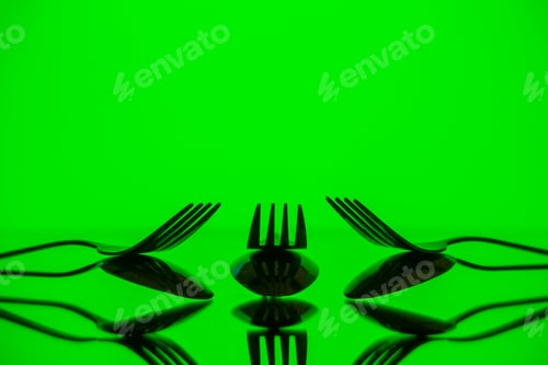 Preview: front view metal forks on green background cutlery kitchen food color photo table dinner restaurant
