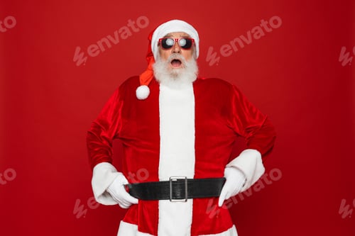 Preview: Santa Claus looking at camera with open mouth surprised advertising Christmas promotion isolated
