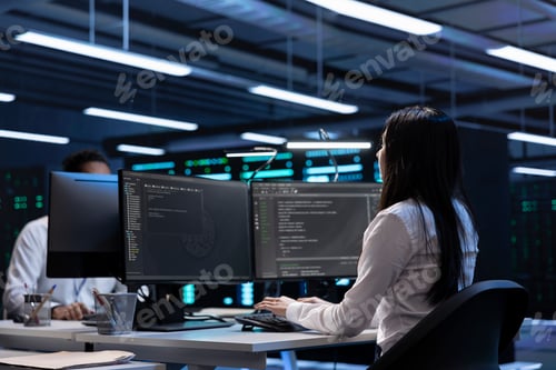 Preview: Software developers in data center running system diagnostic tests on PC