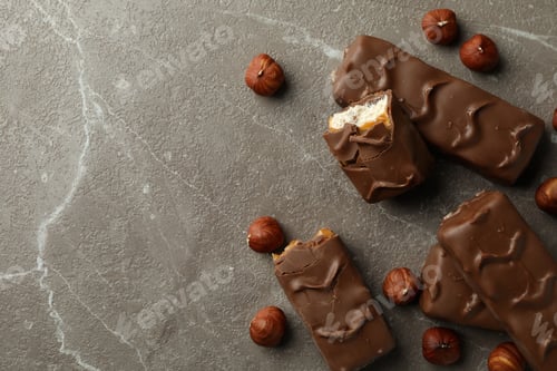Preview: Candy bars and nuts on gray textured table