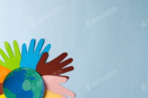 Preview: Paper cut out of multi coloured hands and globe with copy space on blue background