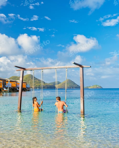 Preview: Couple in a swing on the beach of the tropical Island Saint Lucia or St Lucia Caribbean