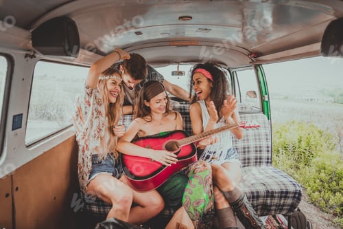 Preview: Happy friends driving a vintage minivan