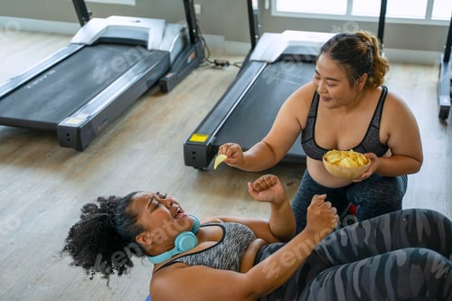 Preview: Plus size women workout at fitness center.