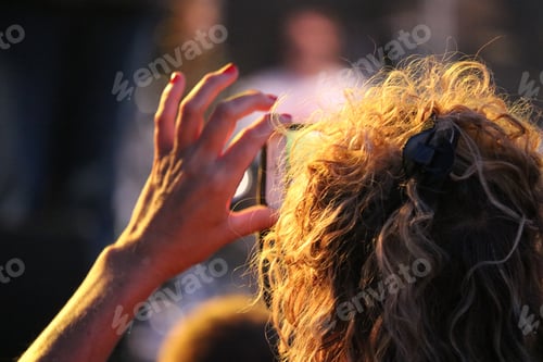 Preview: Woman taking a photo with her phone